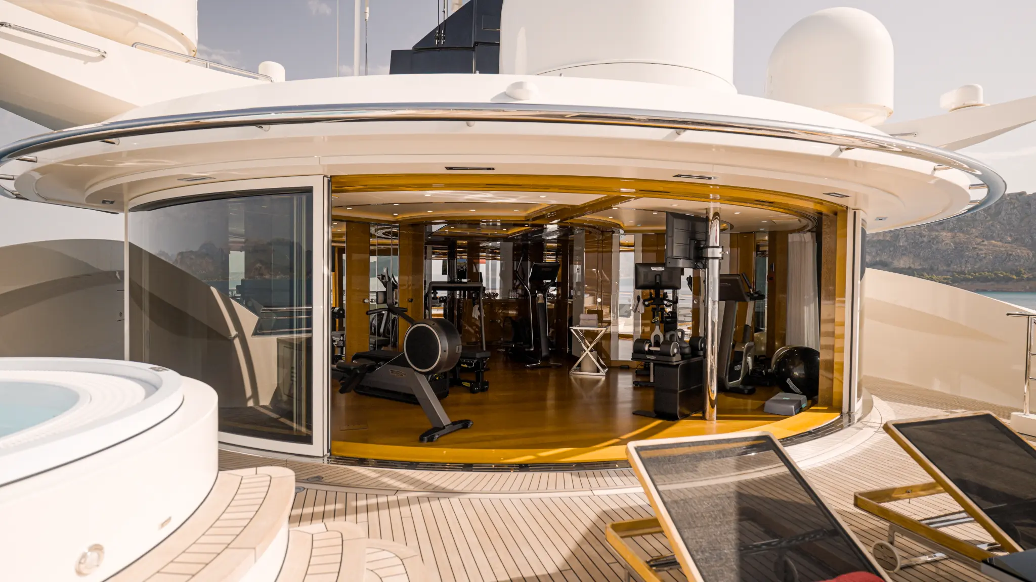 ALFA NERO Gym exterior view with curved glass walls and adjacent Jacuzzi